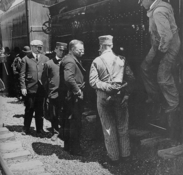 Train214 President Theodore Roosevelt surrounded by people in front of a train.