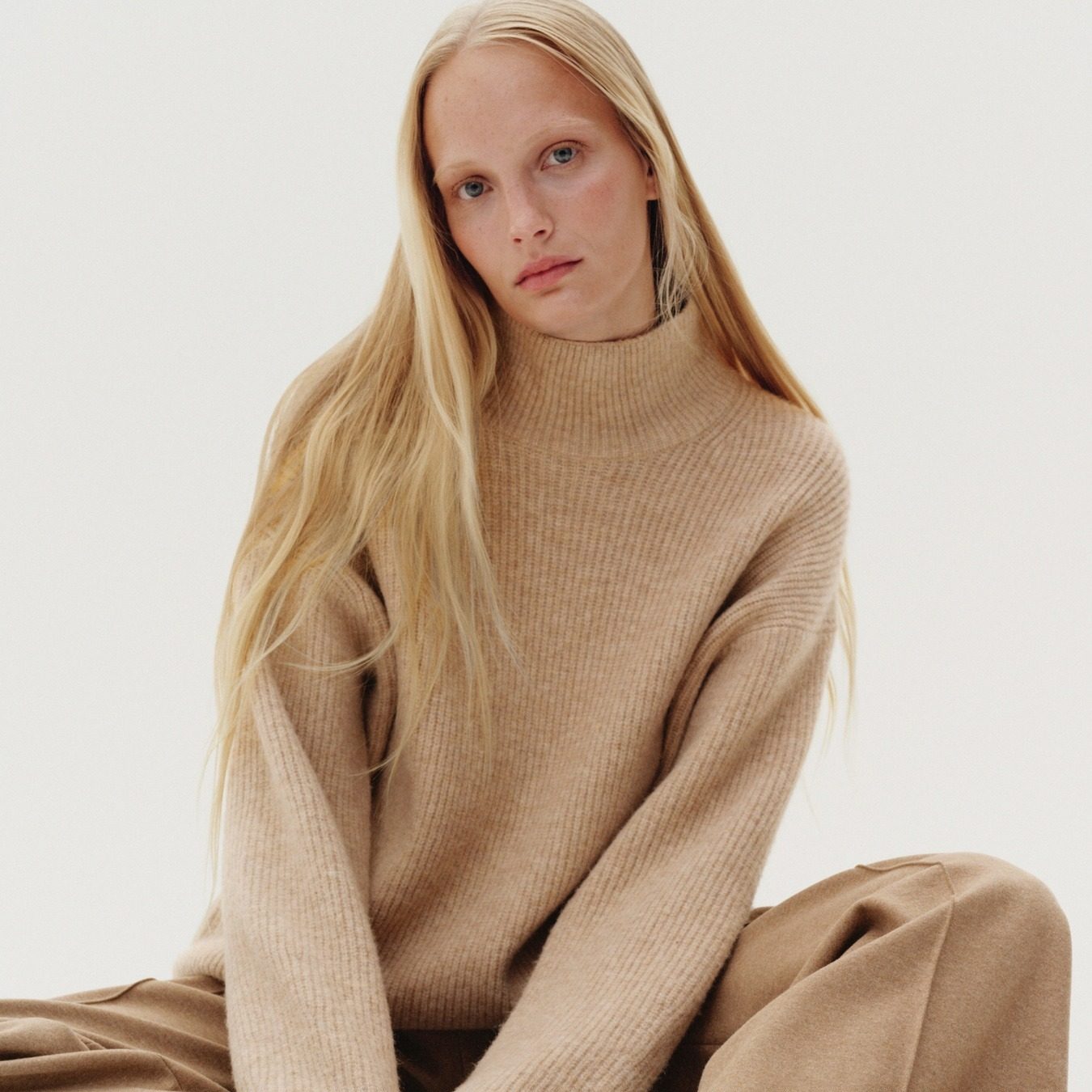 a model in an all tan outfit posing
