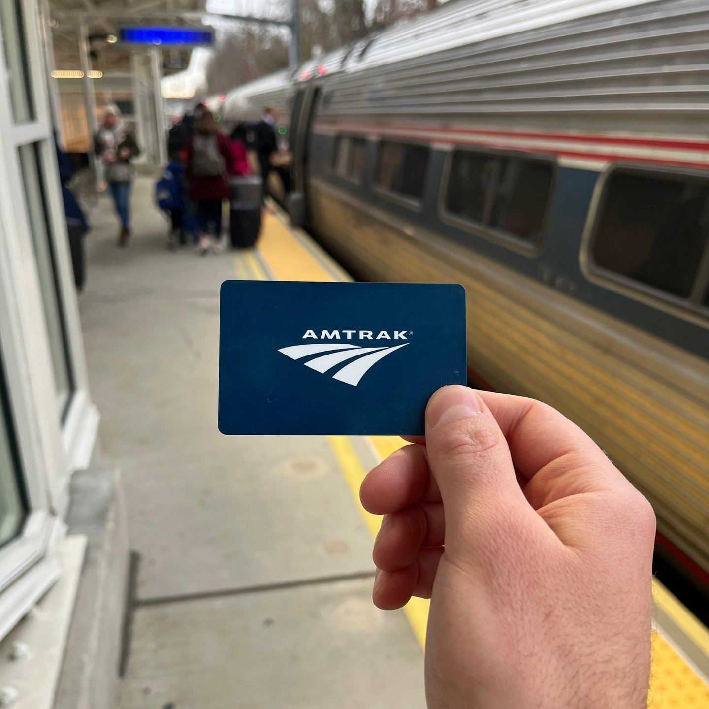 Amtrak hand holding Amtrak card
