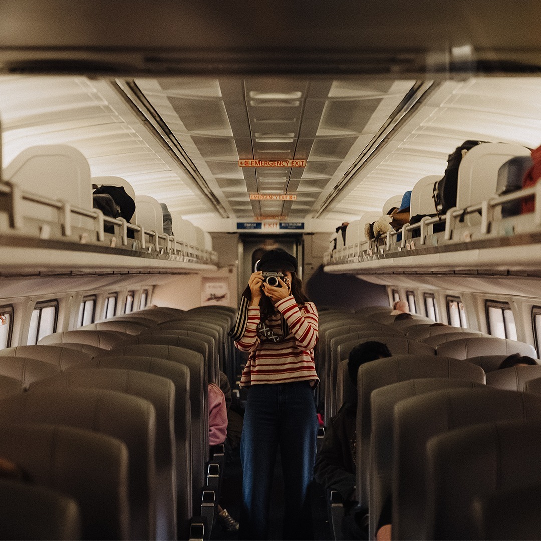 Woman taking a picture in the Amtrak train interior